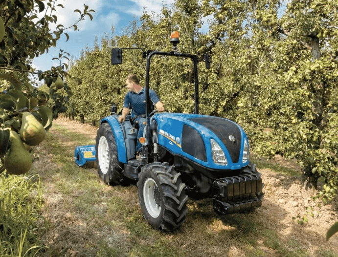 Man driving specialty tractor through vineyard 