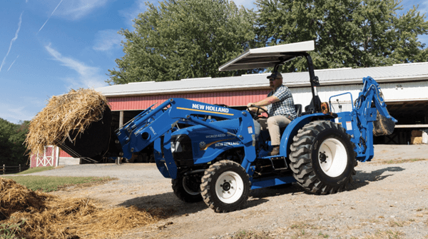 Tractor moving hay
