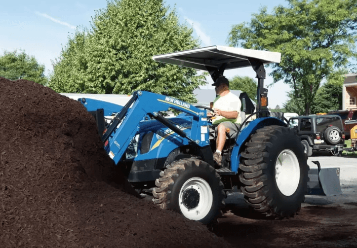 Man using tractor to move dirt