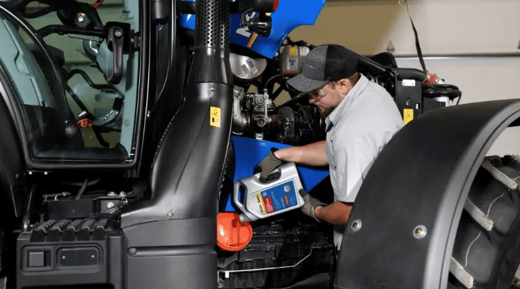 New Holland Technician working on equipment