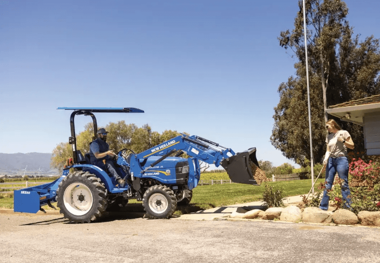 People using a tractor to help with their landscaping