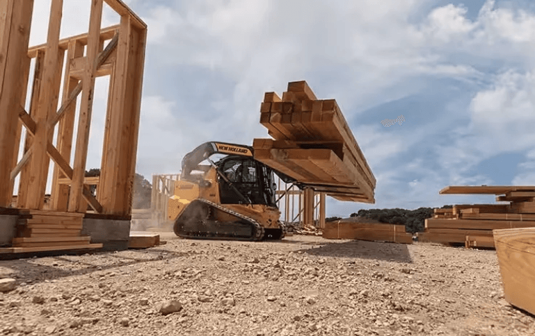 Track Loader moving lumber
