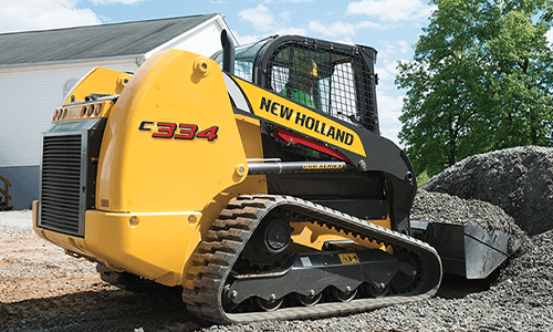 Track loader moving gravel